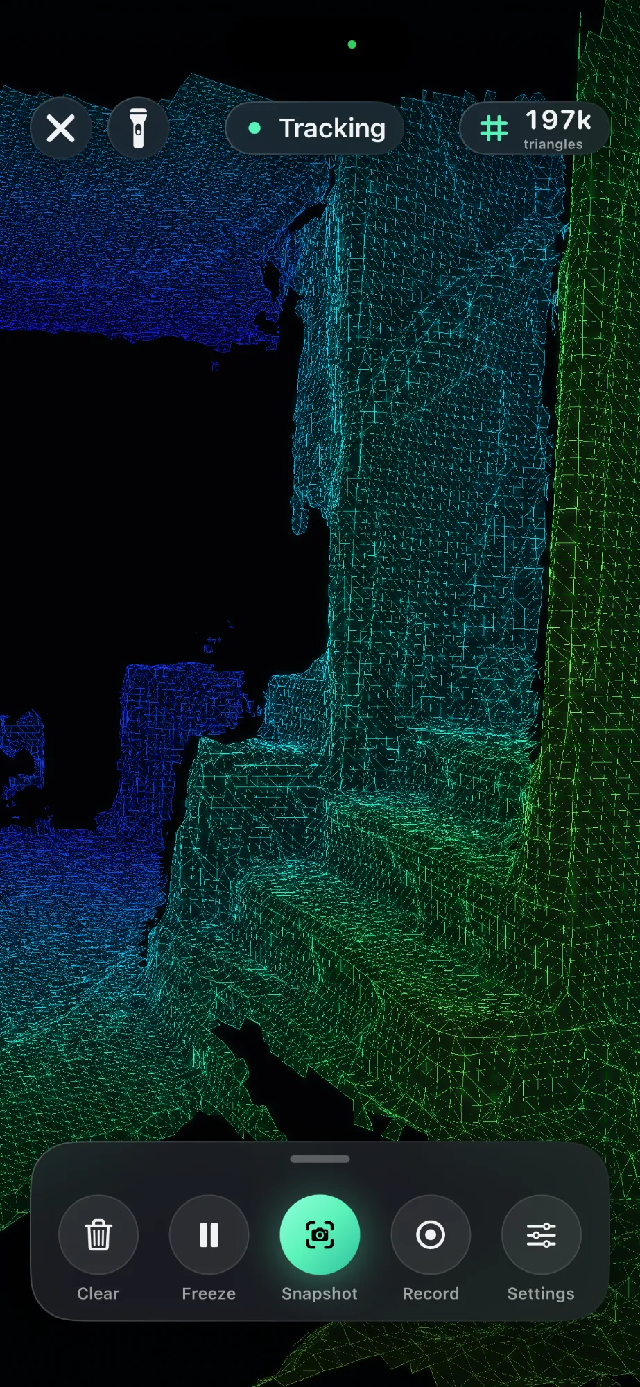 Mesh view: the walls, floor and a doorway of a room drawn as a wire model, blue in the distance and green up close, with 197 thousand triangles